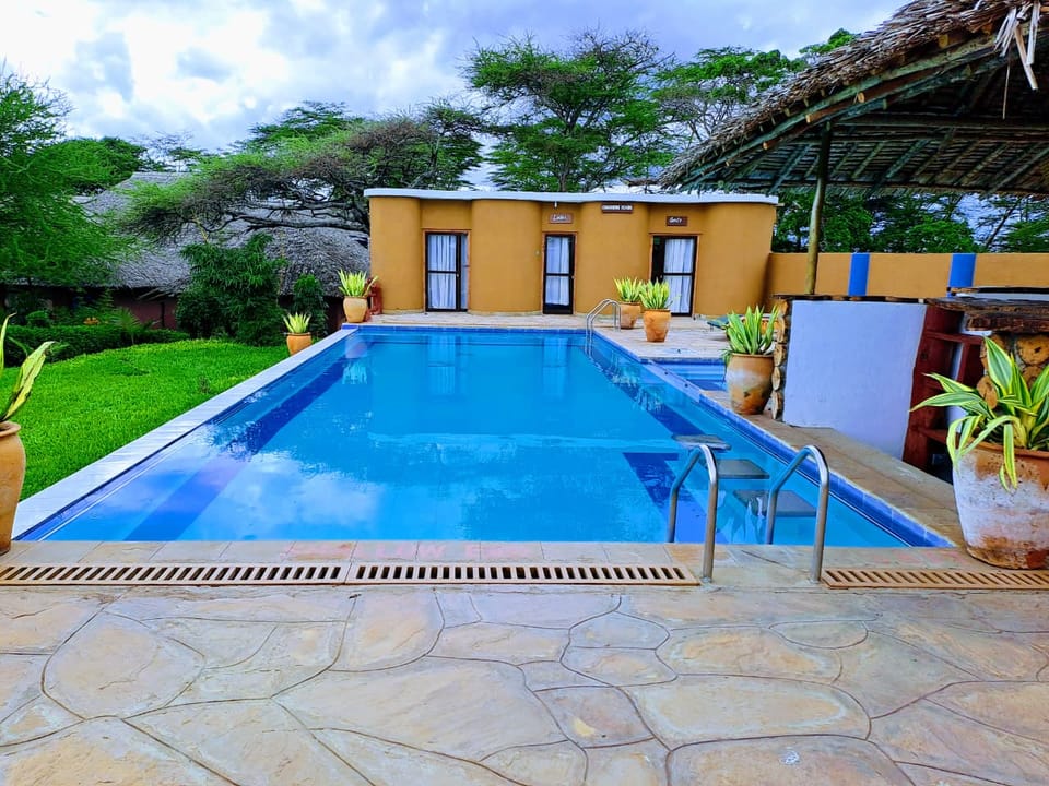 The clear blue swimming pool and stone sun-deck