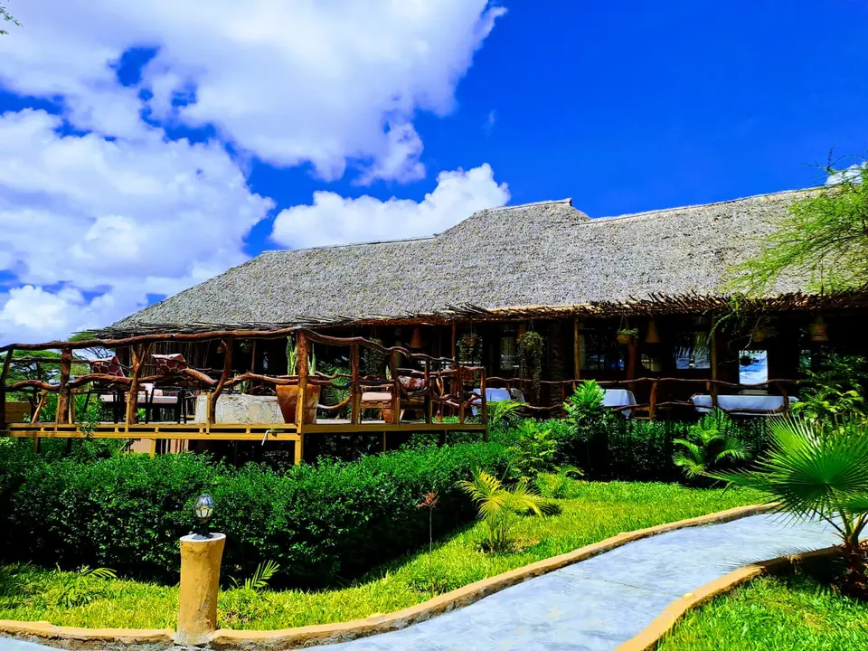 Thatched dining terrace overlooking the gardens