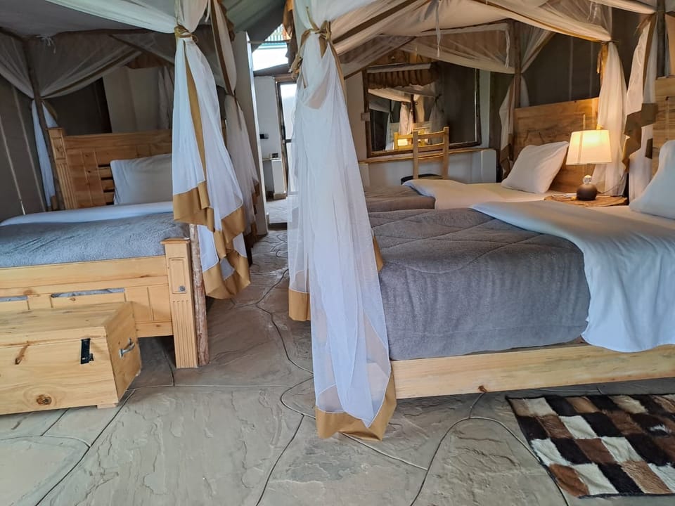 Family tent interior with canopied beds